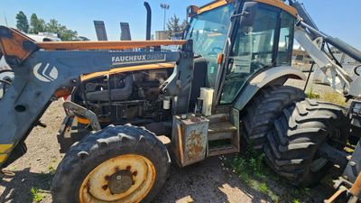 a tractor that is parked on the side of the road