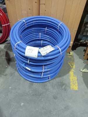 blue hoses are stacked on top of each other in a warehouse