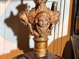 a lamp that has a statue on top of it