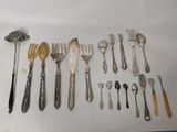 a lot of silverware on a table with spoons and forks