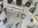 a lot of rings and bracelets that are on a table