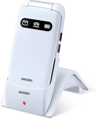 the white phone is sitting on a stand with a red button