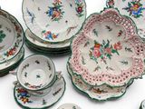 many plates and bowls that are sitting on a table
