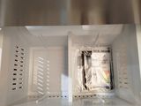 a close up of a microwave with a bag of food inside of it