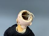a figurine of a man with a piece of bread in his mouth