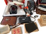 a lot of old cameras and other items on the table