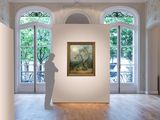 a sculpture in the middle of a room with a painting on the wall