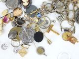 a pile of assorted jewelry on a white surface