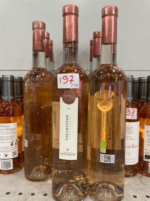 several bottles of wine are lined up on a counter