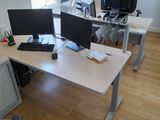a desk with two computer monitors and a laptop on it