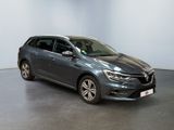 the grey car is parked in a large room with a white wall