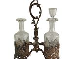 two glass vases on a metal stand with a mirror in the background