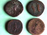 four different types of ancient roman coins on a green surface
