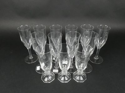 six clear wine glasses sitting on top of a black table