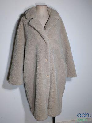 an image of a woman ' s coat on a mannequin stand