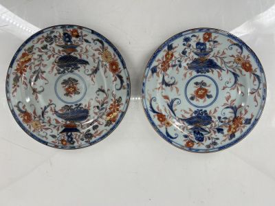 pair of blue and white plates with flowers and birds on them
