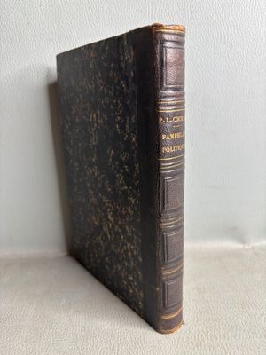 an old book sitting on top of a table next to a white wall