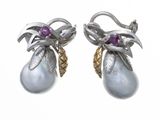 two pairs of earrings with pearls and diamonds on them