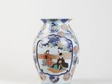 a vase with a picture of a woman and a man sitting on a bench