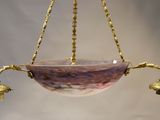 a large bowl with bells hanging from it ' s ceiling