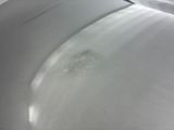 a close up of the hood of a white car