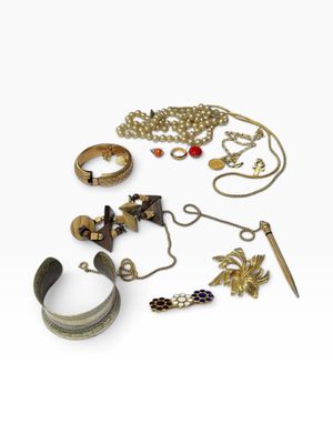 a lot of jewelry that is laying out on the table