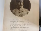 an old photo of a man in a military uniform holding a book