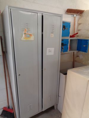 a refrigerator that is next to a stack of boxes in a room