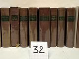 several old books are lined up on a table with a number 32