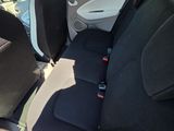 the back seats of a car with a black seat belt and a black seat belt