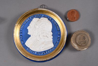 a blue and gold plate with a picture of a man on it