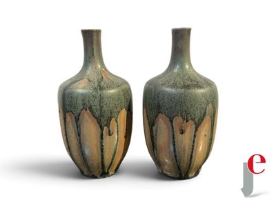 two vases sitting next to each other on a white surface