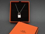 a close up of a necklace in a box on a table