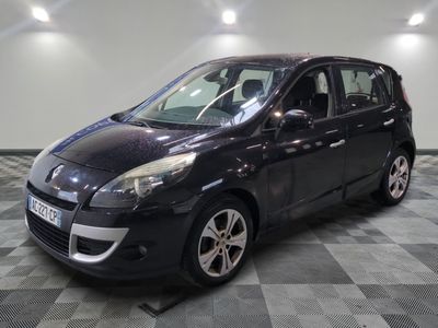 the small black car is parked on a checkered floor