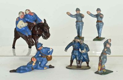 many figurines of men in blue uniforms on a white surface