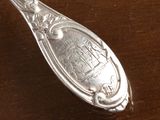 a spoon that is sitting on a wooden table