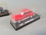 two miniature cars that are sitting on a table