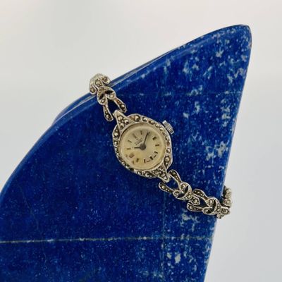 a watch that is sitting on top of a blue object