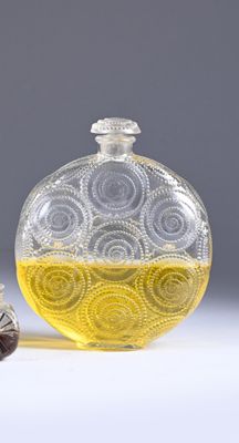 a glass bottle with a yellow liquid inside of it