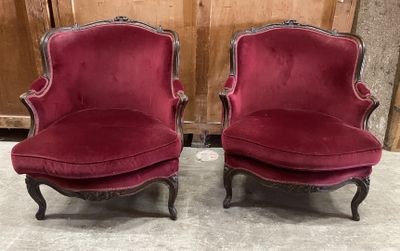 pair of red velvet chairs in the shape of a pair of chairs