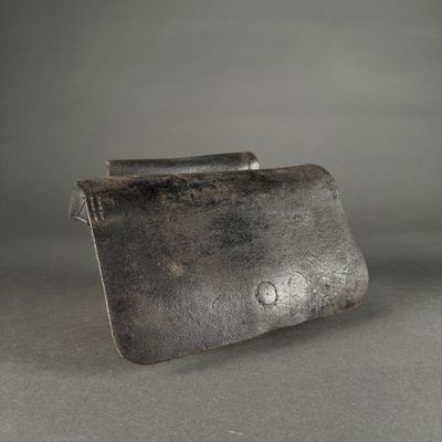 a close up of a small metal object on a gray surface