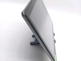 a tablet computer sitting on a stand on a white surface