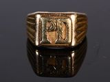 a gold ring with an image of a man ' s face on it