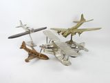 three toy airplanes sitting next to each other on a white surface