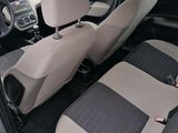 the interior of a small car with two seats and a steering wheel