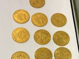 a close up of a box of gold coins on a table