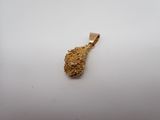 a gold pendant with a small piece of gold on it