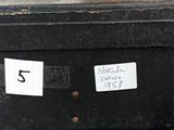a black suitcase that has a label on the side of it