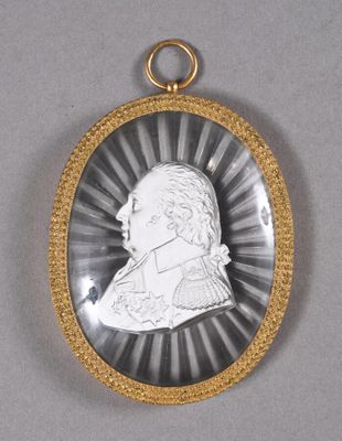 a close up of a silver and gold locke with a picture of a man