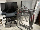 a desk with a computer and a chair in a room